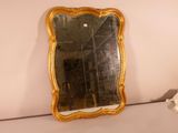 a mirror that is sitting on a shelf in a room
