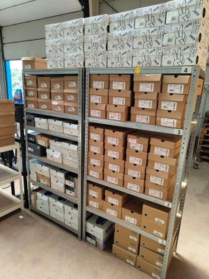 shelves of boxes and boxes are stacked on top of each other in a warehouse