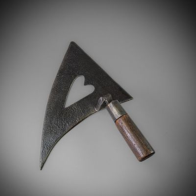 a metal object with a heart on it on a table
