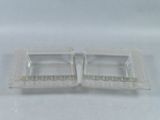 pair of clear glass ashtrays on a white background