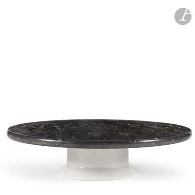a close up of a black and white marble cake on a white pedestal