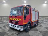 a red fire truck parked in a room with a checkered floor