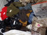 a suitcase full of clothes and clothes sitting on the floor