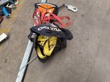 several pairs of skis and ski poles laying on the ground