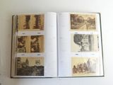 an open book with pictures of a city on it