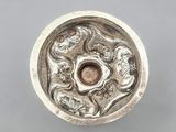 a close up of a metal object on a gray surface