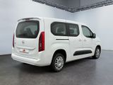 the white van is parked in the large room of the building