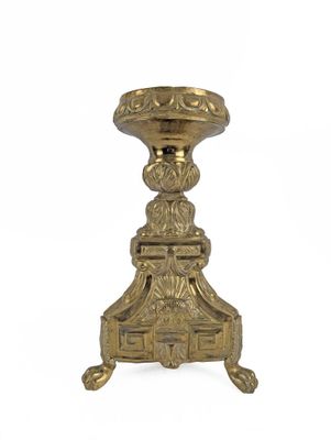 an antique brass candle holder on a white background with a white background