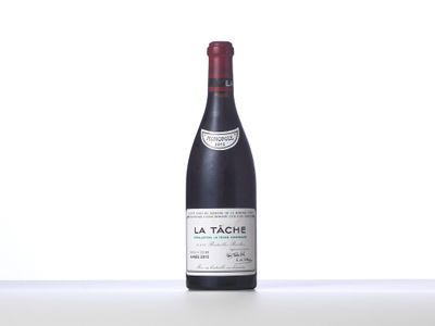 a bottle of red wine sitting on top of a table