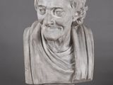 a white marble bust of a man with a scarf around his neck