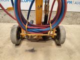 a cart with a bunch of hoses attached to it