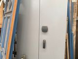 two doors that are leaning against a wall in a room