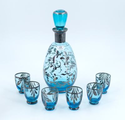 an image of a blue glass decanter set with four shot glasses