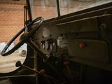 a steering wheel and dashboard of an old military vehicle