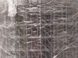 a roll of plastic wrapped around a building in the snow