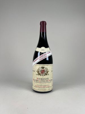 une bouteille de vin posée sur une table blanche