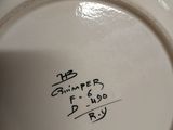 a white plate with writing on it sitting on a table
