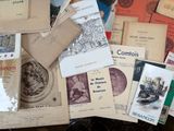 many old books on a table with many different covers