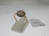 a close up of a gold ring on a white surface