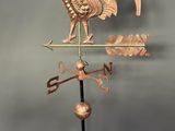 a copper rooster weathervane on a black stand