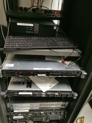 several laptops are stacked on top of each other in a rack