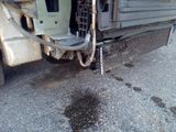 a truck that has some water coming out of the back of it