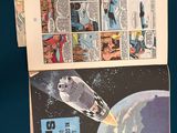 two pages of comics on a table with a blue background