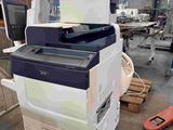 a printer that is sitting on a table in a warehouse