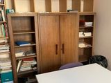 a white table in a room with bookshelves and a cabinet
