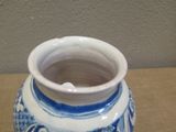 a blue and white vase sitting on a table