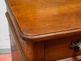 a small wooden chest of drawers with a drawer on top of it