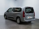 the silver van is parked in a large room with a white wall