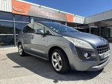 a grey car parked in front of a building in a parking lot
