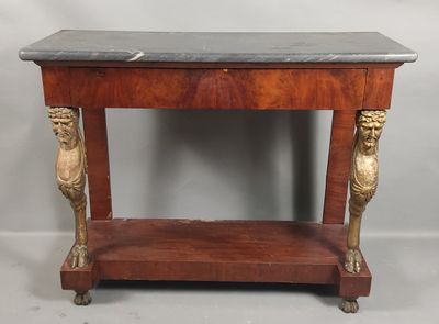 an old wooden table with a marble top and two lions on it