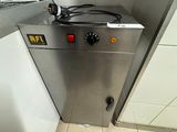 a stainless steel door in a bathroom with a white tile floor