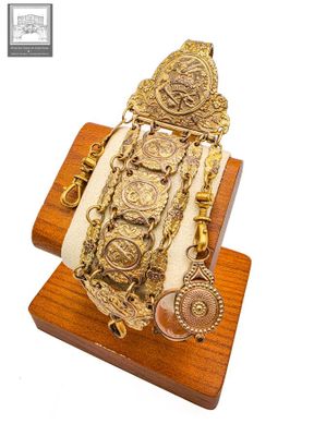 bracelet plaqué or muni d'un support en bois sur lequel est posée une horloge