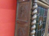 a wooden grandfather clock with a stained glass window