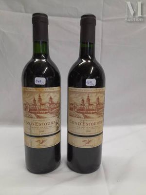 two bottles of wine sitting on top of a table next to each other
