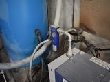 a water heater and a blue tank in a room