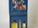 an image of a blue box with two bottles of perfume in it