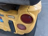 a close up of the rear end of a yellow vehicle