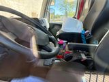 steering wheel of a truck with a bunch of items in it