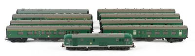 three green train cars sitting next to each other on a white surface