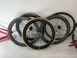 three different types of bicycle wheels sitting on the floor