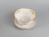 a cup and saucer on a saucer on a table