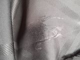 a close up of a person ' s shirt with a stain of paint on it