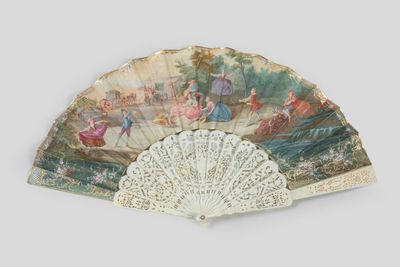 a fan with a painting on it on a white surface