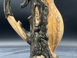 an image of a ceramic vase with a bird on it ' s head