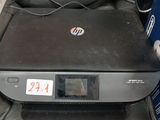 a printer sitting on top of a black leather chair