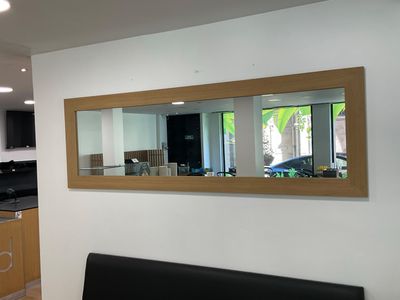 an image of a living room with a couch and a mirror